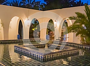 Angled blue and white tiled fountain at dusk in Morocco