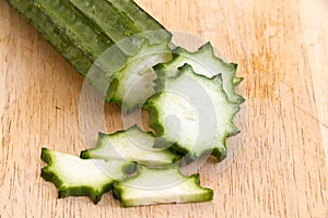 Angled Gourd or fresh loofah slice on the wooden plate