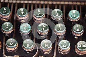 Angled shot of keys on an antique typewriter.