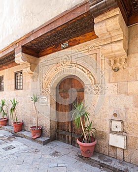 Stone bricks wall with arched wooden door of house of Moustafa Gaafar Al Selehdar, Cairo, Egypt photo