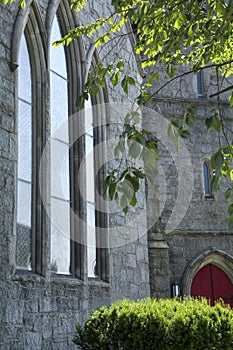 Angled view of vertical church windows,tree, Keene, New Hampshir