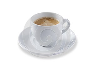 Angled view of a white expresso cup and saucer full of smooth expresso coffee, isolated on white