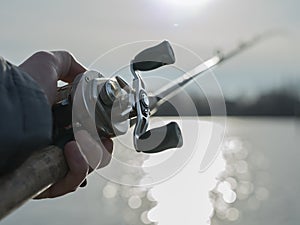 Angler with baitcasting reel in hilights photo
