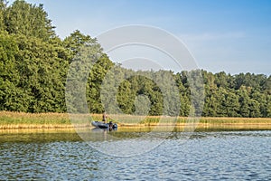 Angler on the boat catch the fish