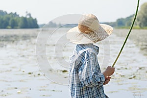 Angler boy is chumming handmade fishing rod
