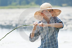 Angler boy is throwing bait of handmade fishing rod