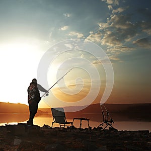 Angler carp angler on the lake with fishing rods