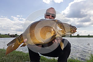 Angler with carp fishing trophy Carp and Fisherman, Carp fishing trophy