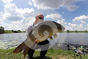 Angler with carp fishing trophy Carp and Fisherman, Carp fishing trophy