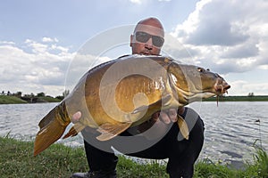 Angler with carp fishing trophy Carp and Fisherman, Carp fishing trophy