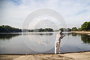 A angler casting at a serene lake