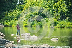 Angler catching the fish. Hobby of real man. Gone fishing. Happy fly fishing. Fisher fishing equipment. Rural getaway