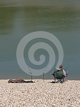 Angler Enjoying Peace At Lake Shore