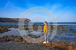 Angler fishing girl in Mediterranean Javea beach