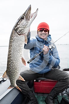 Angler holds pike fish