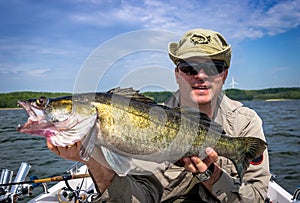Angler with huge walleye fishing trophy