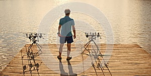 Angler man stand on wooden pier, back view