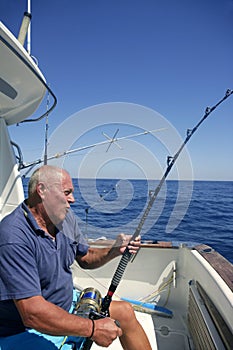 Angler senior big game sport fishing boat photo