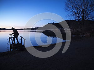 Angler silhouette at the Lake Hopfen