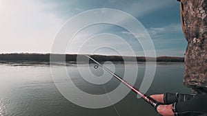 Angler spinning from a boat on a river