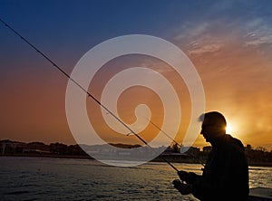 Angler with spinning rod fishing in Mediterranean