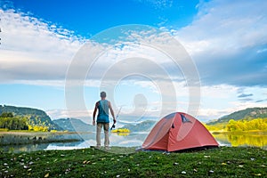 Angler stands on the coast of a lake