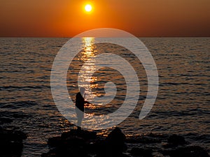 Angler in the sunset on the Adriatic coast in Croatia