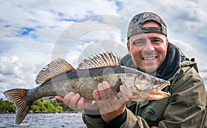 Angler with zander fishing trophy