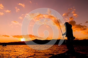 Anglers on a boat fishing in the lake in the evening