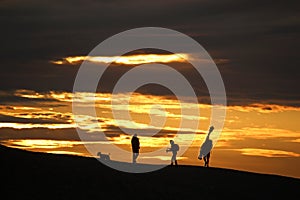 Anglers on Chesil Bank at sunset