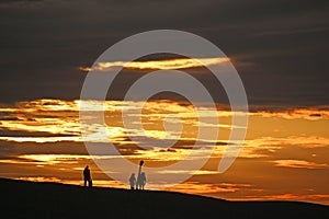 Anglers on Chesil Bank at sunset