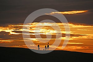 Anglers on Chesil Bank at sunset