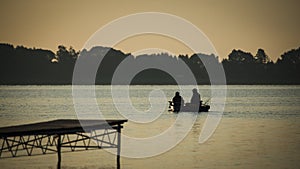 Anglers flowing by small boat