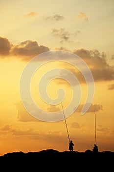 Anglers silhouetted at sunset