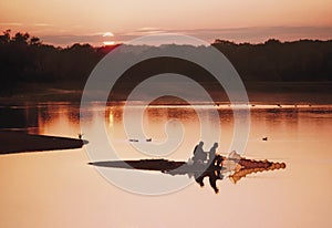 Anglers at sunset