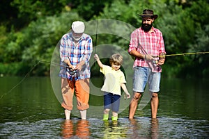 Anglers. Young - adult concept. Fishing. Father, son and grandfather fishing. Hobby and sport activity. Grandfather and