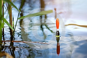 angling - fishing float in the pond water. catch the fish photo