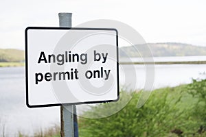 Angling by permit only sign at freshwater lake