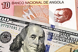 An Angolan kwanza bank note with an American one hundred dollar bill