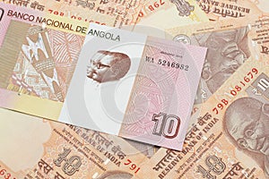 An Angolan ten kwanza bill with Indian ten rupee bank notes