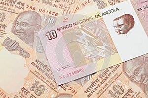 An Angolan ten kwanza bill with Indian ten rupee bank notes photo