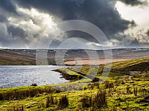 Angram reservoir with drainage channel and mountains.