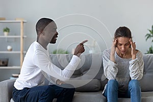 Angry African American man blaming woman, family conflict