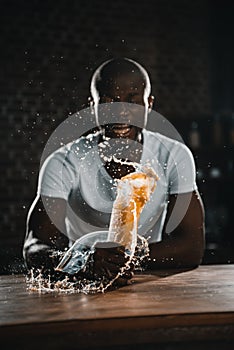 angry african american man screaming and shed juice at table