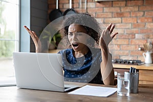 Angry African American woman distressed with computer problem