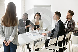 Angry african boss scolding employee for being late at meeting