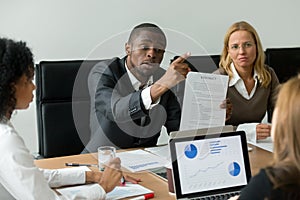 Angry african businessman arguing about bad financial contract,