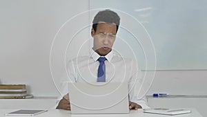 Angry Afro-American Businessman in Anger and Frustration Working on Laptop