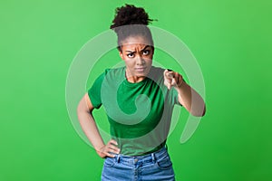 Angry afro woman pointing finger at camera