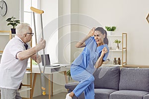 Angry aggressive elderly man threatening to his caregiver woman